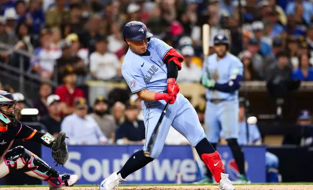 Toronto Blue Jays' Kazuma Okamoto hits a three-run home run against the San Diego Padres in the fifth inning of a baseball game Friday, July 10, 2026, in San Diego. (AP Photo/Derrick Tuskan)