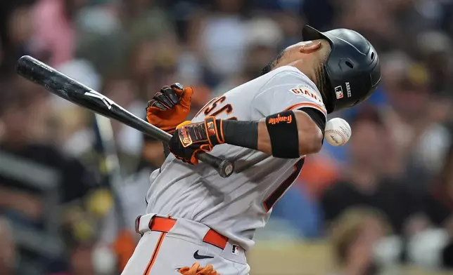 San Francisco Giants' Luis Arraez is hit by a pitch while batting during the fourth inning of a baseball game against the San Diego Padres Thursday, July 30, 2026, in San Diego. (AP Photo/Gregory Bull)