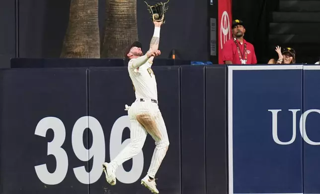 San Diego Padres center fielder Jackson Merrill makes the catch for the out on San Francisco Giants' Christian Koss during the eighth inning of a baseball game Thursday, July 30, 2026, in San Diego. (AP Photo/Gregory Bull)