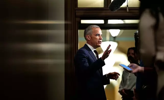 FILE - Prime Minister Mark Carney takes questions from journalists as he arrives on Parliament Hill in Ottawa before a meeting of the federal cabinet, June 2, 2026. (Justin Tang/The Canadian Press via AP, File)