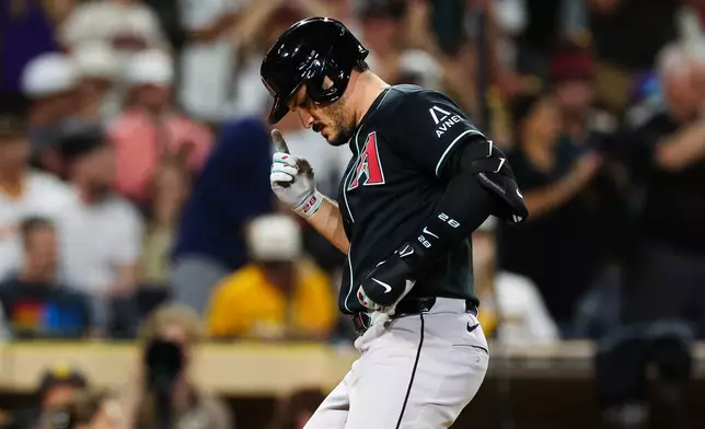 Arizona Diamondbacks' Nolan Arenado, gestures as he crosses the plate after hitting a solo home run against the San Diego Padres in the sixth inning of a baseball game Thursday, July 9, 2026, in San Diego. (AP Photo/Derrick Tuskan)