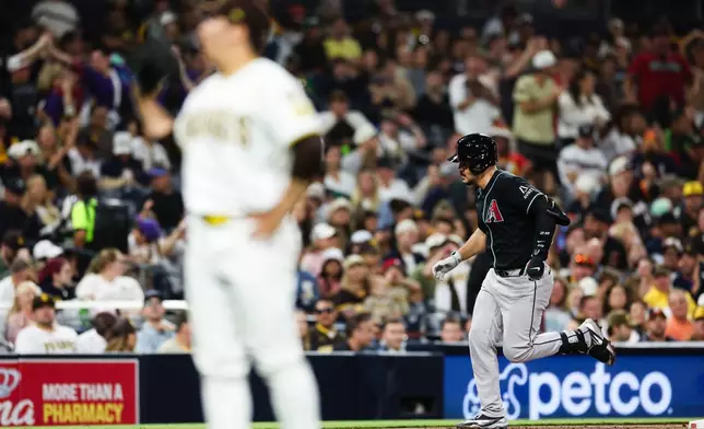 Arizona Diamondbacks' Nolan Arenado, right, runs the bases after hitting a solo home run off San Diego Padres' Yuki Matsui in the sixth inning of a baseball game Thursday, July 9, 2026, in San Diego. (AP Photo/Derrick Tuskan)