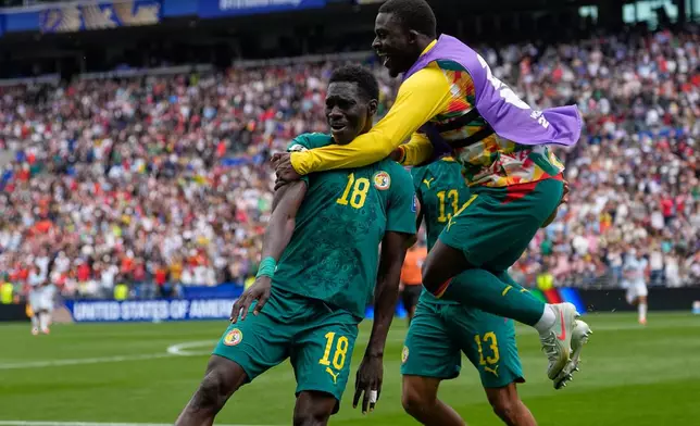 Senegal's Ismaila Sarr (18) is congratulated after scoring his side's 2nd goal during the World Cup round of 32 soccer match between Belgium and Senegal in Seattle, Wednesday, July 1, 2026. (AP Photo/Lindsey Wasson)