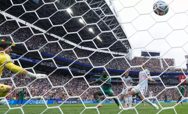 Senegal's Habib Diarra (21) scores their first goal past Belgium goalkeeper Thibaut Courtois, left, and Belgium's Brandon Mechele, right, during the World Cup round of 32 soccer match between Belgium and Senegal in Seattle, Wednesday, July 1, 2026. (AP Photo/Abbie Parr)