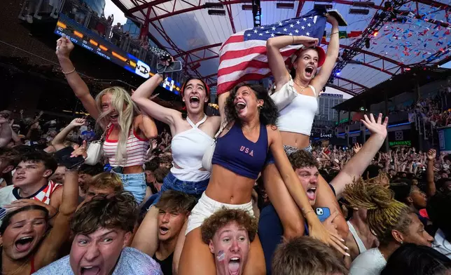 Fans celebrate after a United States goal during a watch party for a World Cup soccer match against Bosnia at the KC Live! entertainment district Wednesday, July 1, 2026, in Kansas City, Mo. (AP Photo/Charlie Riedel)