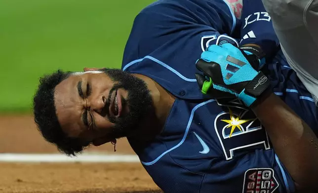 Tampa Bay Rays' Junior Caminero reacts after being hit by a pitch by St. Louis Cardinals' Riley O'Brien in the third inning of the MLB baseball All-Star Game between the American League and National League, Tuesday, July 14, 2026, in Philadelphia. (AP Photo/Matt Rourke)