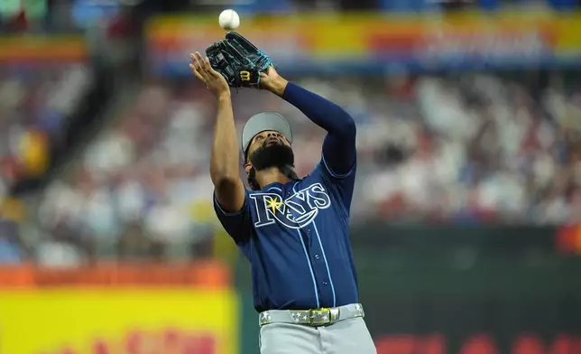 Tampa Bay Rays' Junior Caminero catches a fly ball by Los Angeles Dodgers' Max Muncy in the second inning during the MLB baseball All-Star Game between the American League and National League, Tuesday, July 14, 2026, in Philadelphia. (AP Photo/Matt Rourke)
