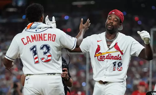 Tampa Bay Rays' Junior Caminero, left, greets St. Louis Cardinals' Jordan Walker during the MLB baseball All-Star Home Run Derby, Monday, July 13, 2026, in Philadelphia. (AP Photo/Matt Rourke)