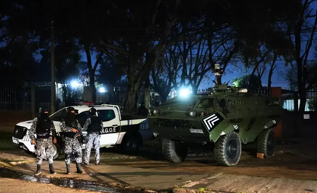 Police patrol by a U.S. donated Mamba armored military vehicle in the Marconi neighborhood of Montevideo, Uruguay, Sunday, July 26, 2026. (AP Photo/Matilde Campodonico)