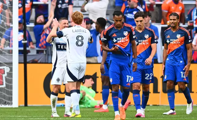 Vancouver Whitecaps FC midfielder Ryan Gauld, left, celebrates his first half goal with Oliver Larraz, right, during a match against FC Cincinnati in Cincinnati, Wednesday, July 22, 2026. (AP Photo/Ben Jackson)