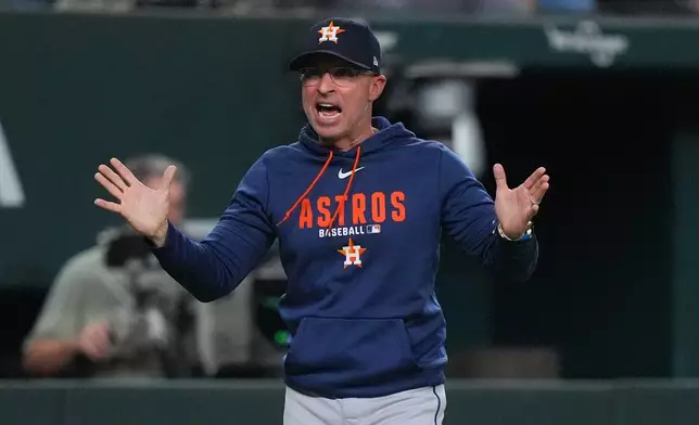 Houston Astros manager Joe Espada questions a call during the fourth inning of a baseball game against the Texas Rangers, Friday, July 10, 2026, in Arlington, Texas. (AP Photo/LM Otero)