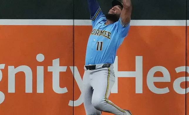 Milwaukee Brewers left fielder Jackson Chourio makes the catch on a ball hit by Arizona Diamondbacks' Lourdes Gurriel Jr. in the sixth inning of a baseball game, Friday, July 3, 2026, in Phoenix. (AP Photo/Rick Scuteri)