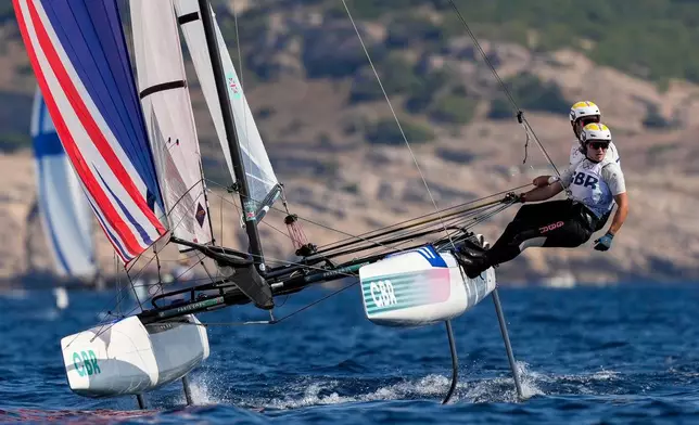 FILE - Anna Burnet and John Gimson, of Britain, compete in the Nacra 17 mixed multihull sailing race during the 2024 Summer Olympics, Aug. 6, 2024, in Marseille, France. (AP Photo/Carolyn Kaster, File)
