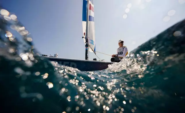 FILE - Marit Bouwmeester, of the Netherlands, sails back to the harbor after ILCA 6 dinghy class final race was postponed during the 2024 Summer Olympics, Aug. 6, 2024, in Marseille, France. (AP Photo/Jacquelyn Martin, File)