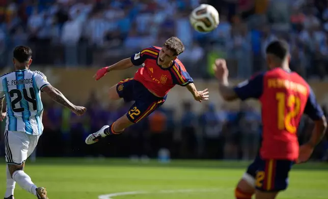 Spain's Pau Cubarsi (22) leaps in the air after he is fouled by Argentina's Enzo Fernandez (24) during the World Cup final soccer match between Spain and Argentina in East Rutherford, N.J., near New York, Sunday, July 19, 2026. (AP Photo/Frank Franklin II)
