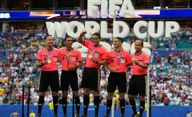 Referee Jesus Valenzuela Saez, center, of Venezuela, and his team pose with their medals after the World Cup third-place playoff soccer match between France and England in Miami Gardens, Fla., Saturday, July 18, 2026. (AP Photo/Lynne Sladky)