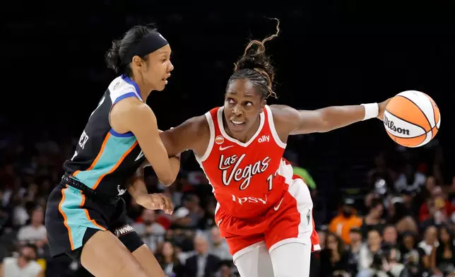 Las Vegas Aces guard Chelsea Gray (12) drives against New York Liberty guard Rebekah Gardner (7) during the first half of an WNBA basketball game Thursday, July 30, 2026, in Las Vegas. (Steve Marcus/Las Vegas Sun via AP)