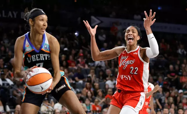 Las Vegas Aces center A'ja Wilson (22) reacts after missing a basket as New York Liberty guard Rebekah Gardner (7) makes the rebound during the first half of an WNBA basketball game Thursday, July 30, 2026, in Las Vegas. (Steve Marcus/Las Vegas Sun via AP)