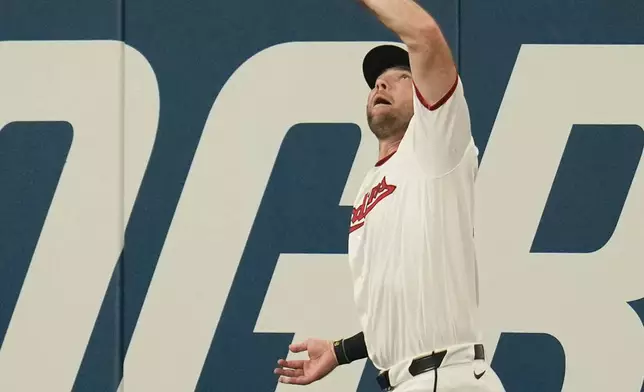 Cleveland Guardians right fielder David Fry catches a fly ball hit by Pittsburgh Pirates' Brandon Lowe for a sacrifice as Ryan O'Hearn scores in the second inning of the second baseball game of a split doubleheader in Cleveland, Saturday, June 18, 2026. (AP Photo/Sue Ogrocki)