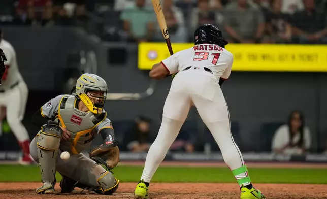 Pittsburgh Pirates catcher Rafael Flores Jr., left, reaches for a wild pitch thrown by pitcher Gregory Soto to Kahlil Watson, right, allowing Brayan Rocchio to score, in the eighth inning of the second baseball game of a split doubleheader in Cleveland, Saturday, June 18, 2026. (AP Photo/Sue Ogrocki)