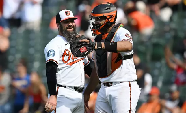 Baltimore Orioles catcher Samuel Basallo, right, and pitcher Andrew Kittredge, left, celebrate after a baseball game against the Kansas City Royals, Sunday, July 12, 2026, in Baltimore. (AP Photo/Gail Burton)