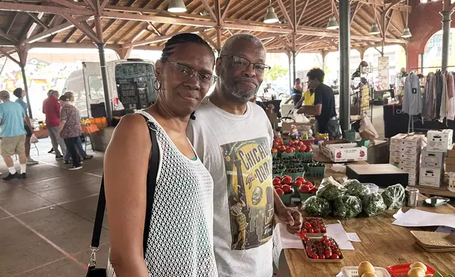 Karen and Ronald Hall shop for produce at the Eastern Market in Detroit on Tuesday, June 30, 2026. (AP Photo/Corey Williams)