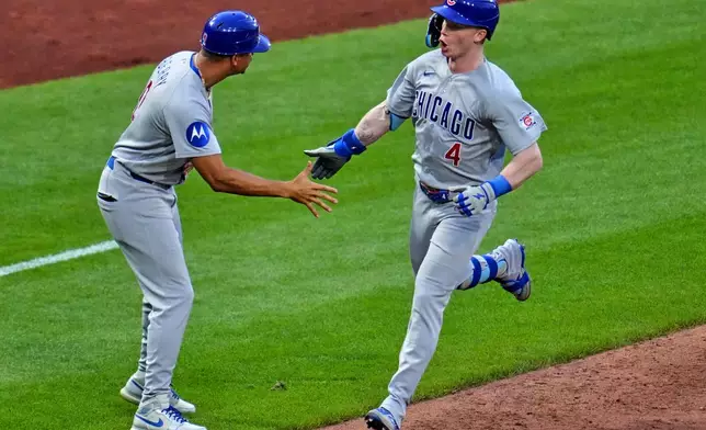 Chicago Cubs' Pete Crow-Armstrong (4) is greeted by third base coach Quintin Berry, left, as he rounds third after hitting a solo home run off Pittsburgh Pirates pitcher Jared Jones during the sixth inning of a baseball game in Pittsburgh, Friday, July 24, 2026. (AP Photo/Gene J. Puskar)