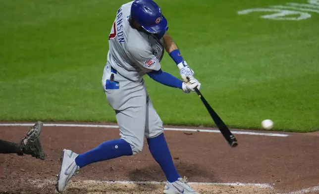 Chicago Cubs' Dansby Swanson singles off Pittsburgh Pirates pitcher Yohan Ramírez, driving in a run, during the tenth inning of a baseball game in Pittsburgh, Friday, July 24, 2026. (AP Photo/Gene J. Puskar)
