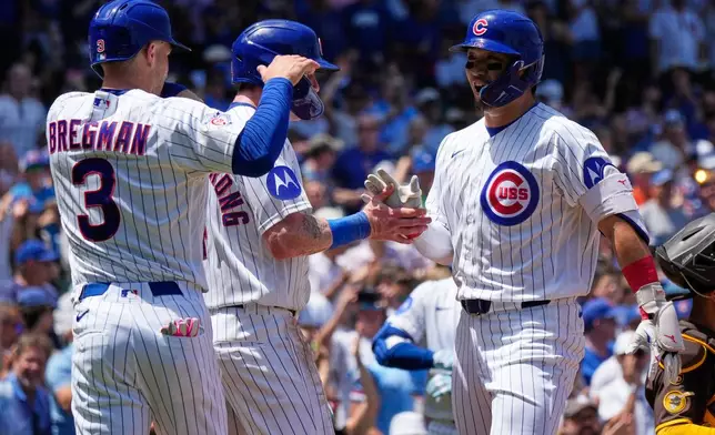 Chicago Cubs' Seiya Suzuki, right, of Japan, celebrates with Alex Bregman, left, and Pete Crow-Armstrong after hitting a three-run home run during the first inning of a baseball game against the San Diego Padres in Chicago, Wednesday, July 1, 2026. (AP Photo/Nam Y. Huh)