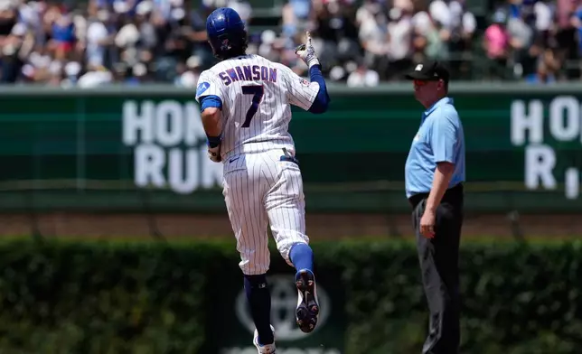 Chicago Cubs' Dansby Swanson celebrates as he rounds the bases after hitting a three-run home run during the third inning of a baseball game against the San Diego Padres in Chicago, Wednesday, July 1, 2026. (AP Photo/Nam Y. Huh)