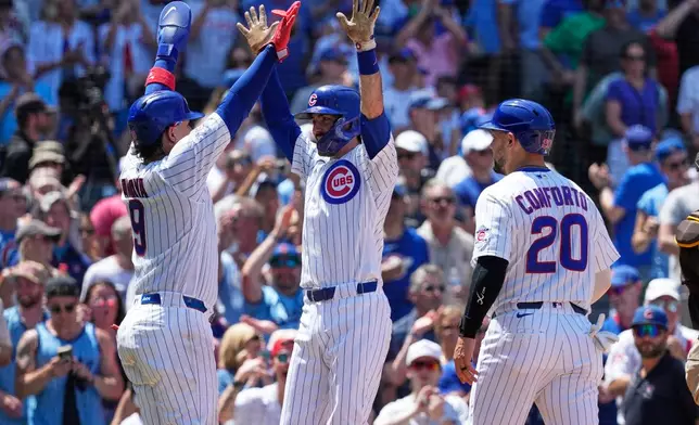 Chicago Cubs' Dansby Swanson, center, celebrates with Miguel Amaya, left, and Michael Conforto after hitting a three-run home run during the third inning of a baseball game against the San Diego Padres in Chicago, Wednesday, July 1, 2026. (AP Photo/Nam Y. Huh)