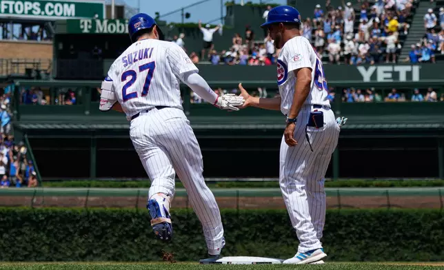 Chicago Cubs' Seiya Suzuki, left, of Japan, celebrates with first base coach Jose Javier after hitting a three-run home run during the first inning of a baseball game against the San Diego Padres in Chicago, Wednesday, July 1, 2026. (AP Photo/Nam Y. Huh)