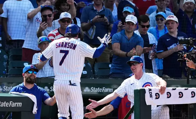 Chicago Cubs' Dansby Swanson (7) is congratulated by manager Craig Counsell, right, after hitting a grand slam during the eighth inning of a baseball game against the San Diego Padres in Chicago, Wednesday, July 1, 2026. (AP Photo/Nam Y. Huh)