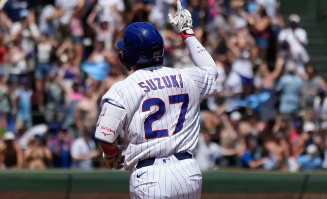 Chicago Cubs' Seiya Suzuki, left, of Japan, celebrates as he rounds the bases after hitting a three-run home run during the first inning of a baseball game against the San Diego Padres in Chicago, Wednesday, July 1, 2026. (AP Photo/Nam Y. Huh)