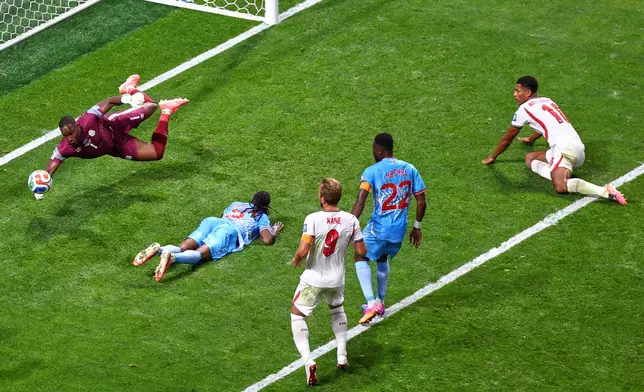 Congo goalkeeper Lionel Mpasi (1) saves from England's Jude Bellingham (10) during the World Cup round of 32 soccer match between England and Congo in Atlanta, Wednesday, July 1, 2026. (AP Photo/Colin Hubbard)