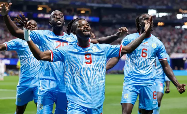 Congo's Brian Cipenga (9) celebrates with teammates after scoring their first goal during the World Cup round of 32 soccer match between England and Congo in Atlanta, Wednesday, July 1, 2026. (AP Photo/Butch Dill)