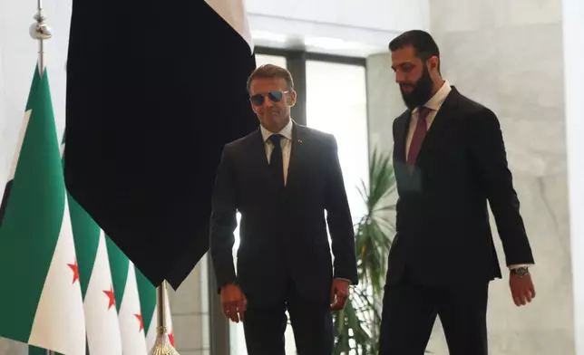 Syrian President Ahmad al-Sharaa, right, meets French President Emmanuel Macron at the presidential palace in Damascus, Syria, Tuesday, July 7, 2026. (AP Photo/Ghaith Alsayed)