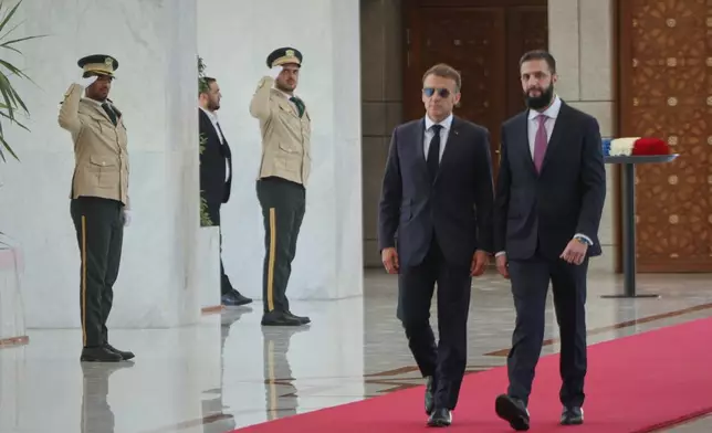 Syrian President Ahmad al-Sharaa, right, meets French President Emmanuel Macron at the presidential palace in Damascus, Syria, Tuesday, July 7, 2026. (AP Photo/Ghaith Alsayed)