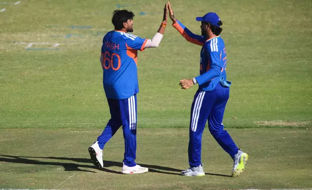 India's bowler Yash Thakur, right, celebrates with teammate Tilak Varma, after taking a wicket during the third T20 cricket match between Zimbabwe and India in Harare, Zimbabwe, Sunday, July 26, 2026. (AP Photo/Wonder Mashura)