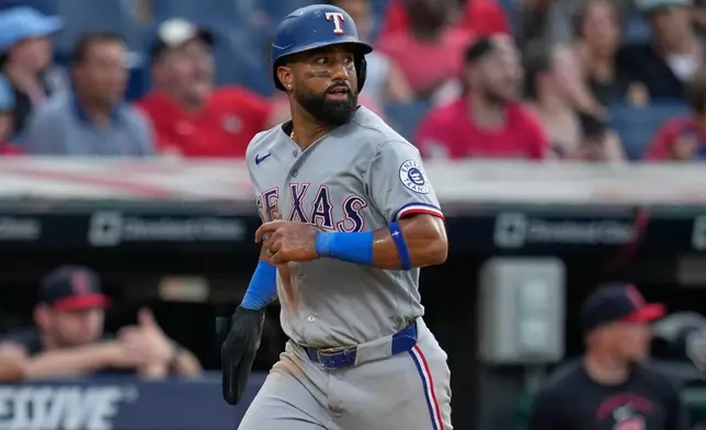 Texas Rangers' Ezequiel Duran runs towards home plate to score on an error by Cleveland Guardians left fielder Cooper Ingle in the seventh inning of a baseball game in Cleveland, Tuesday, June 30, 2026. (AP Photo/Sue Ogrocki)