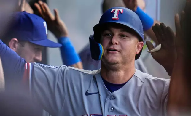 Texas Rangers' Joc Pederson is congratulated in the dugout after hitting a home run in the third inning of a baseball game against the Cleveland Guardians in Cleveland, Tuesday, June 30, 2026. (AP Photo/Sue Ogrocki)