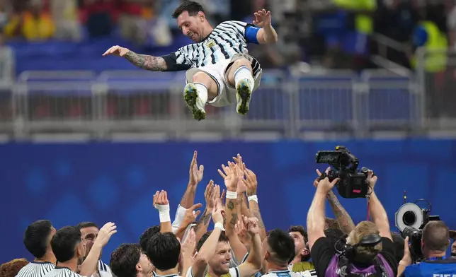 Argentina players toss teammate Lionel Messi (10) into the air as they celebrate after the World Cup round of 16 soccer match between Argentina and Egypt in Atlanta, Tuesday, July 7, 2026. (AP Photo/Jacob Kupferman)