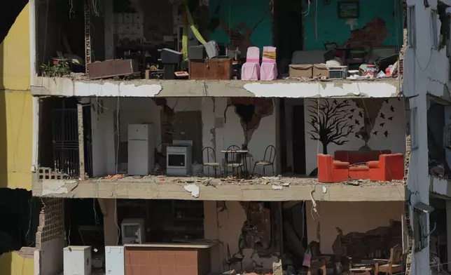 Furniture remains inside apartments damaged in the earthquakes in La Guaira, Venezuela, Monday, July 6, 2026. (AP Photo/Ariana Cubillos)