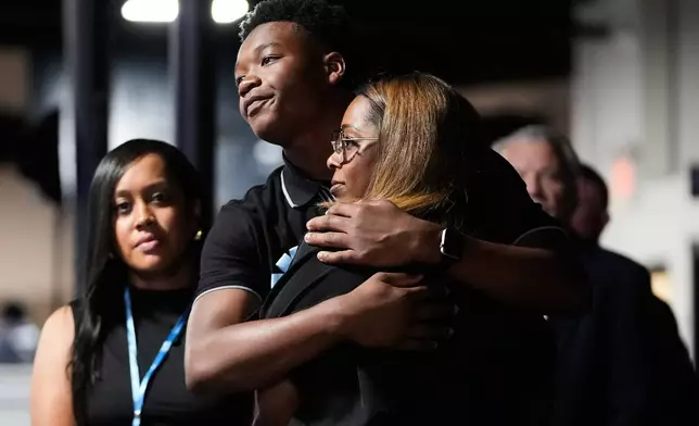 Attendees hug during a memorial service for Nolan Xavier Wells, an 18-year-old found dead after taking a July 4 boat trip with friends, Monday, July 20, 2026, in Ocean Springs, Miss. (AP Photo/Gerald Herbert)
