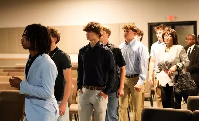 Football teammates of Nolan Xavier Wells, an 18-year-old found dead after taking a July 4 boat trip with friends, attend his memorial service Monday, July 20, 2026, in Ocean Springs, Miss. (AP Photo/Gerald Herbert)