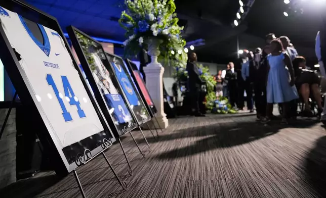 Sports jerseys are framed during a memorial service for Nolan Xavier Wells, an 18-year-old found dead after taking a July 4 boat trip with friends, Monday, July 20, 2026, in Ocean Springs, Miss. (AP Photo/Gerald Herbert)