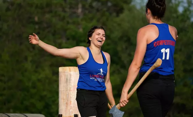 Karolina Urbanová, of the Czech Republic, and Stephanie Naud, of Canada, celebrate after Urbanovà broke the world record in the women's underhand chop event during the Lumberjack World Championships, Saturday, July 18, 2026, in Hayward, Wis. (AP Photo/Ellen Schmidt)
