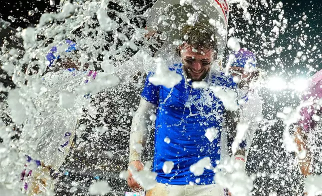 Kansas City Royals' Carter Jensen is doused by teammates after their baseball game against the San Diego Padres, Friday, July 17, 2026, in Kansas City, Mo. (AP Photo/Charlie Riedel)