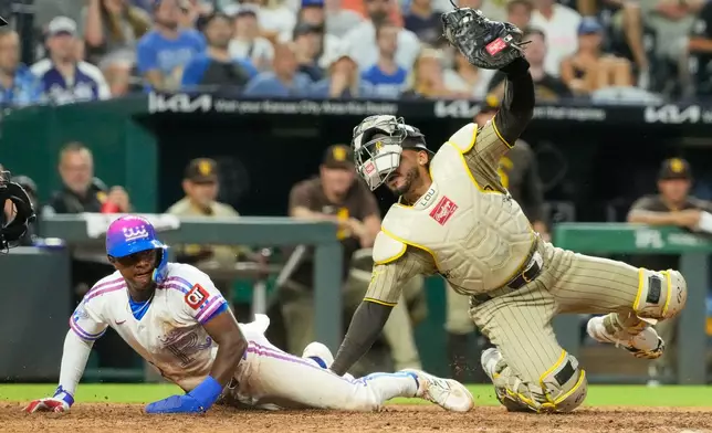 Kansas City Royals' Tyler Tolbert is tagged out at home by San Diego Padres catcher Luis Campusano as he tried to score on a fielder's choice hit into by Kansas City Royals' Vinnie Pasquantino during the eighth inning of a baseball game Friday, July 17, 2026, in Kansas City, Mo. (AP Photo/Charlie Riedel)