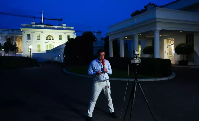 A reporter from Buro, a Russian-language YouTube channel, films a video in front of the White House as President Donald Trump speaks in the East Room, Thursday, July 16, 2026, in Washington. (AP Photo/Julia Demaree Nikhinson)